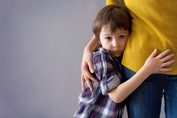 Tired-Boy-Grabbing-Mothers-leg